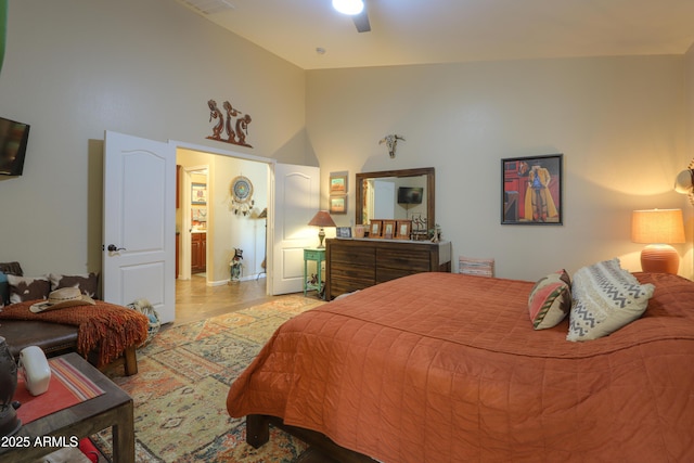 bedroom with ceiling fan and high vaulted ceiling