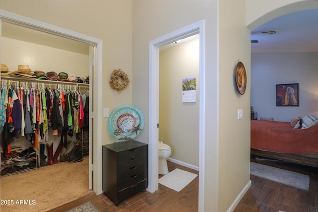 bathroom with hardwood / wood-style floors and toilet