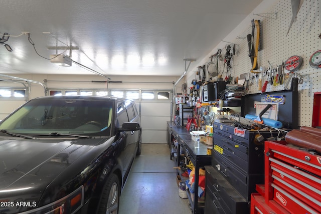 garage with a garage door opener and a workshop area