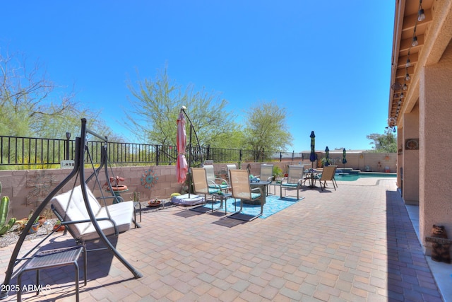 view of patio featuring a fenced in pool