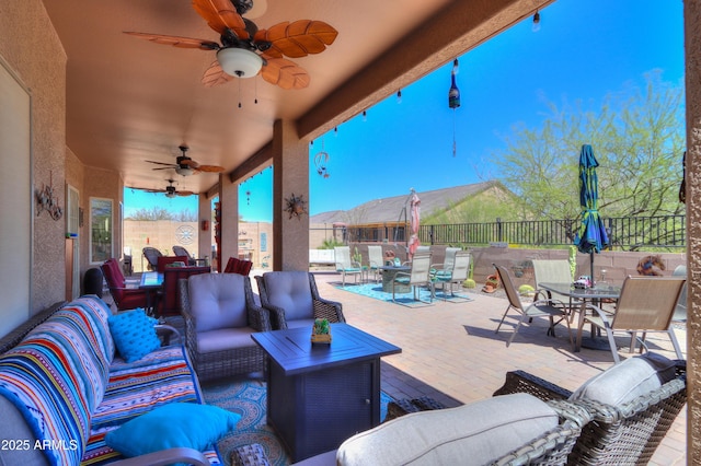 view of patio with an outdoor living space and ceiling fan