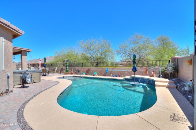 view of pool with a jacuzzi, a patio area, and pool water feature