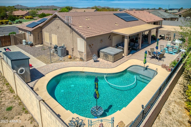 view of swimming pool featuring a patio area and central air condition unit