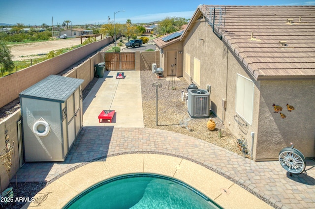 view of pool with a patio area and central air condition unit