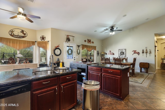 kitchen with sink, vaulted ceiling, a center island with sink, stainless steel dishwasher, and ceiling fan