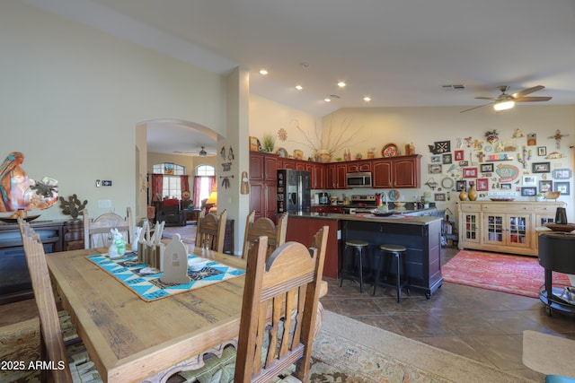 dining space featuring high vaulted ceiling and ceiling fan