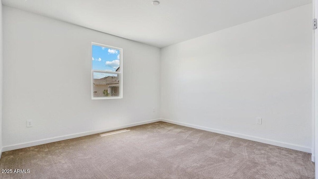 empty room featuring baseboards and carpet floors