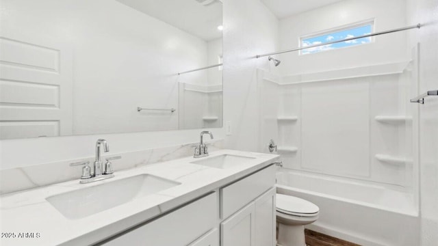 bathroom featuring a sink, bathing tub / shower combination, toilet, and double vanity