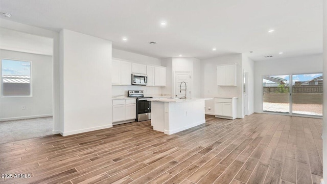 kitchen featuring light countertops, light wood-style flooring, white cabinets, and stainless steel appliances