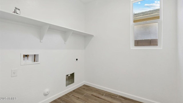 laundry room with laundry area, baseboards, hookup for an electric dryer, hookup for a washing machine, and wood tiled floor