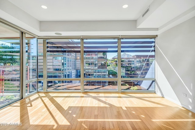 interior space featuring visible vents and hardwood / wood-style floors