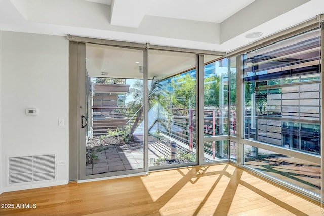 doorway featuring visible vents and wood finished floors