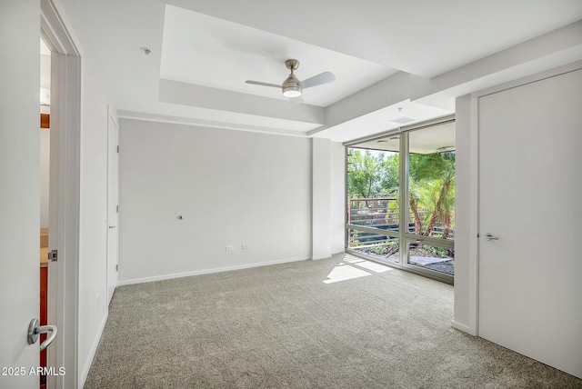 carpeted empty room featuring visible vents, baseboards, and ceiling fan