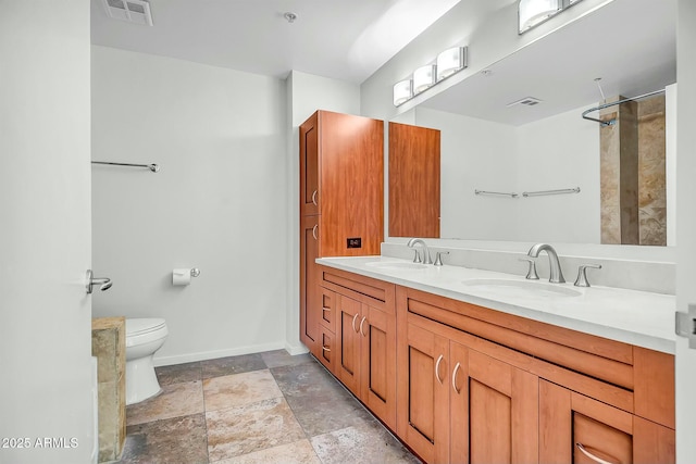 bathroom with visible vents, toilet, and a sink