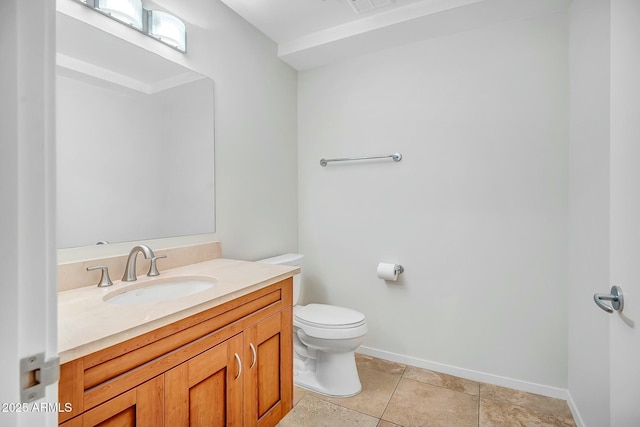 bathroom featuring tile patterned flooring, toilet, vanity, and baseboards