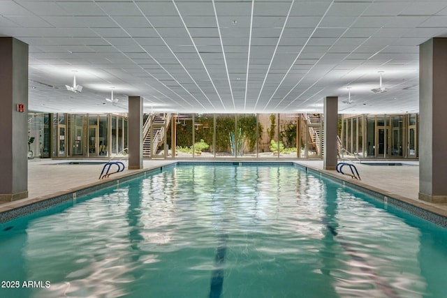 pool featuring stairway, a patio, and an indoor hot tub