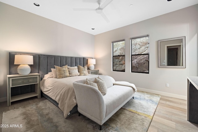 bedroom with light hardwood / wood-style floors and ceiling fan