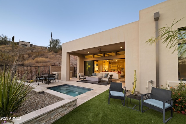 back of property featuring a pool, an outdoor living space, and a patio