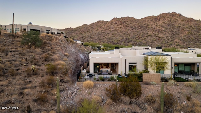 back house at dusk with a mountain view