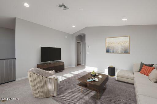 living room with lofted ceiling and carpet floors