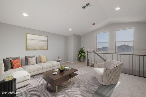 living room with vaulted ceiling and carpet floors