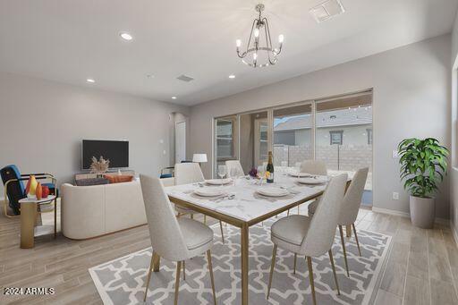 dining area featuring a chandelier and light hardwood / wood-style flooring