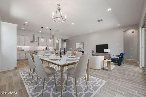 dining room featuring a chandelier and light wood-type flooring