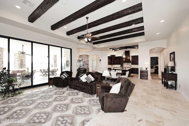 living room with ceiling fan and beam ceiling