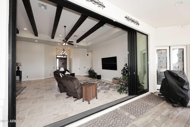 living room with ceiling fan, beamed ceiling, and french doors