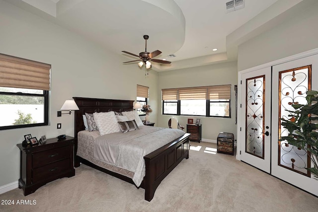 carpeted bedroom with ceiling fan and french doors