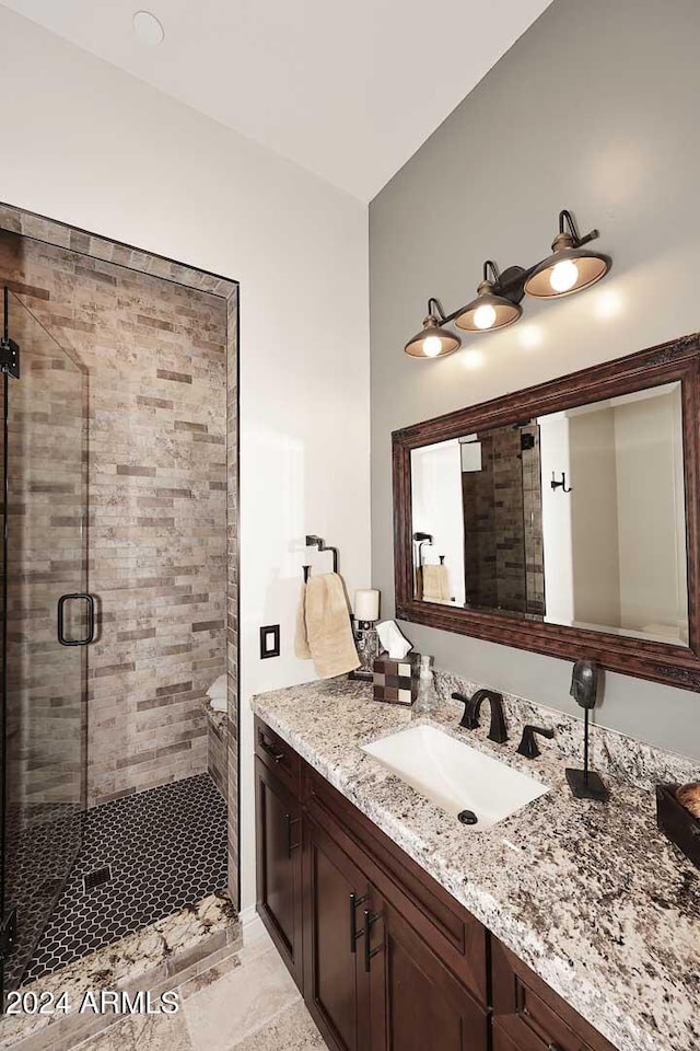 bathroom featuring vanity and an enclosed shower