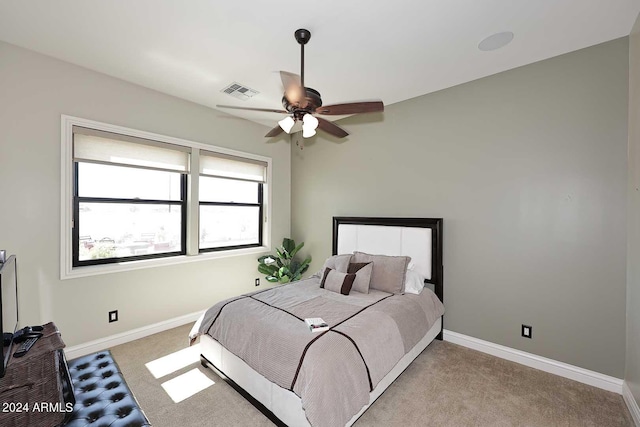 bedroom with ceiling fan and light colored carpet