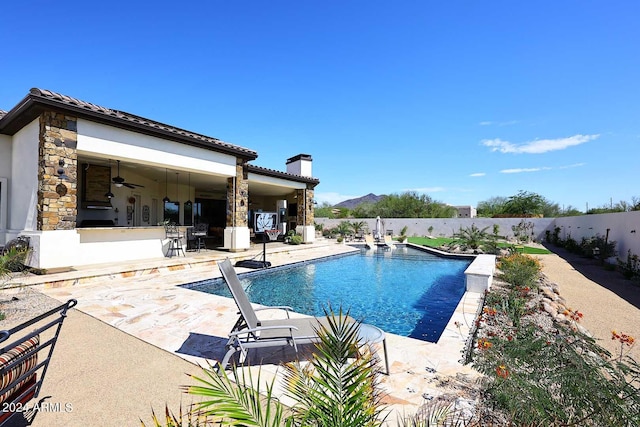 view of pool with ceiling fan and a patio area