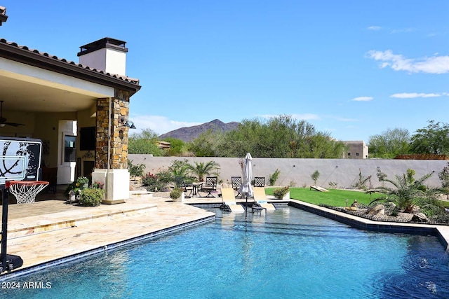 view of swimming pool featuring a mountain view and a patio area