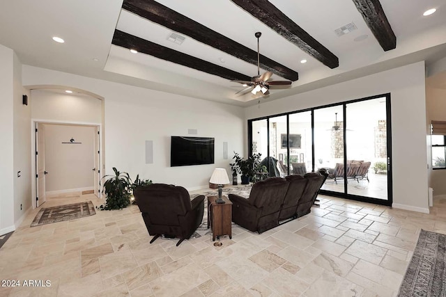 living room featuring beam ceiling and ceiling fan