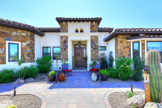 property entrance with a patio area