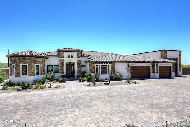 mediterranean / spanish-style home with a garage