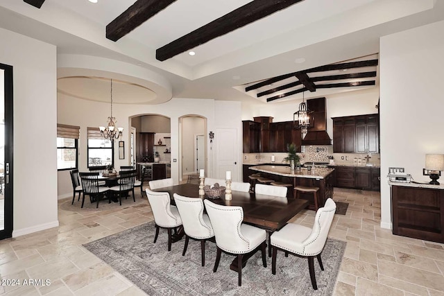 dining room featuring a notable chandelier and beam ceiling