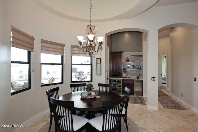 dining area with beverage cooler and a chandelier