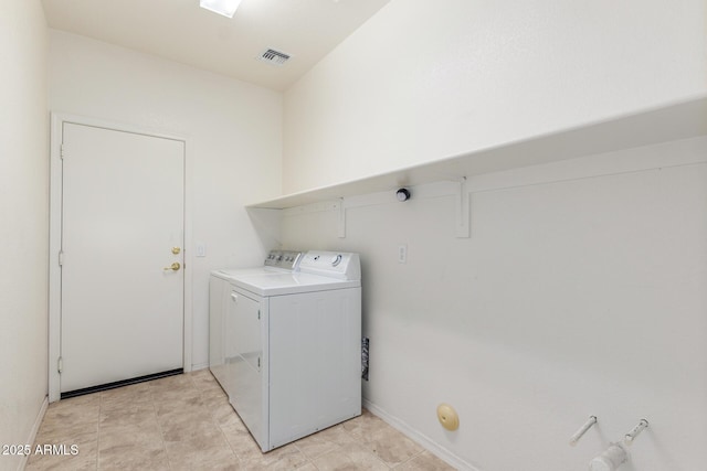 washroom with washer and clothes dryer, laundry area, visible vents, light tile patterned flooring, and baseboards