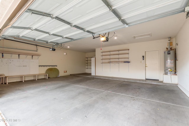 garage featuring water heater and a garage door opener