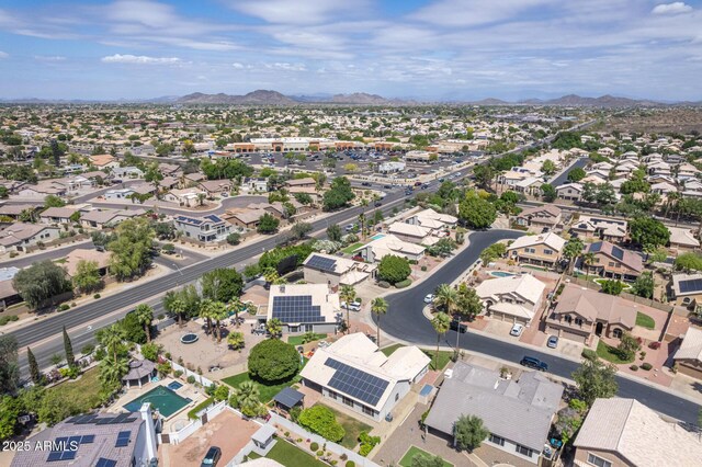 drone / aerial view featuring a residential view and a mountain view