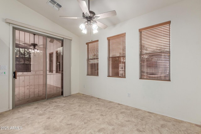 unfurnished room featuring ceiling fan, lofted ceiling, visible vents, and baseboards