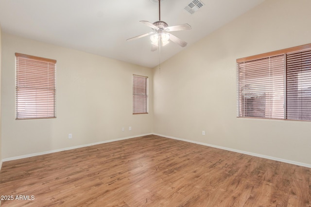 unfurnished room with light wood-style flooring, baseboards, visible vents, lofted ceiling, and ceiling fan