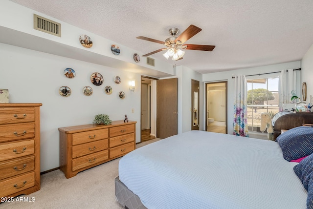 bedroom featuring light colored carpet, ceiling fan, a textured ceiling, and visible vents