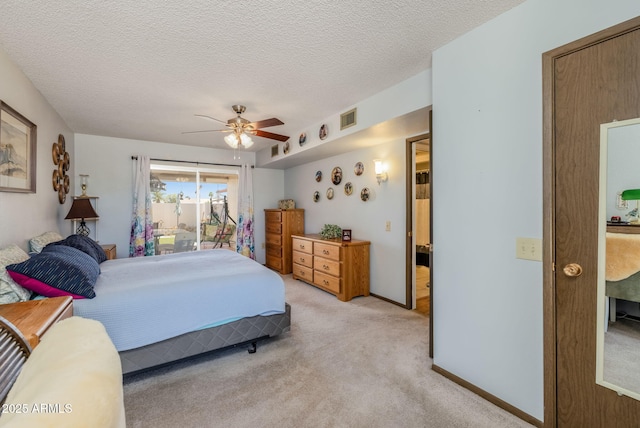 bedroom with light colored carpet, ceiling fan, a textured ceiling, and visible vents