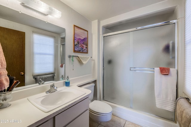 full bathroom featuring vanity, tile patterned flooring, a shower with shower door, and toilet