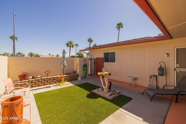 view of yard with fence and a patio