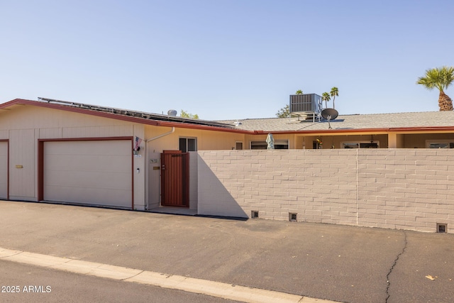 exterior space featuring central air condition unit and fence