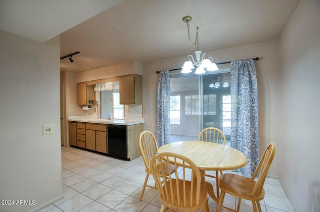 tiled dining area with sink and an inviting chandelier